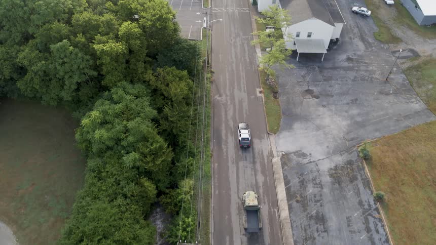 Trucks driving through a small town