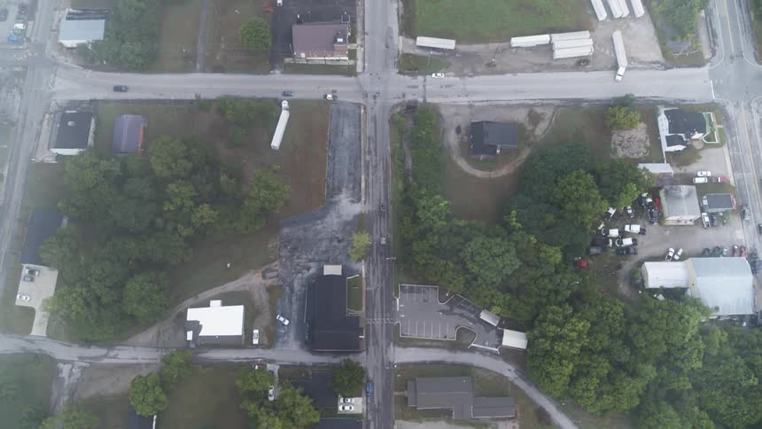 Cars drive on a town street