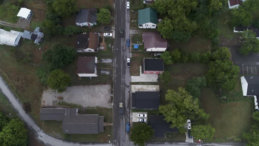 A truck driving through a neighborhood