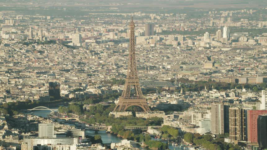 The eiffel tower stands tall above the other city buildings