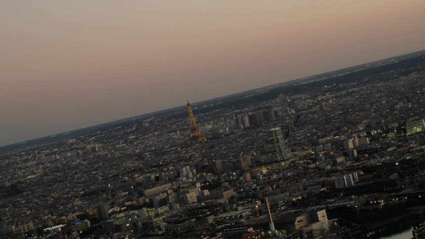 The eiffel tower lit up at sunset
