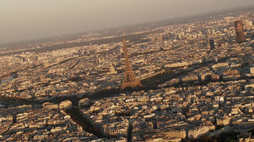 The city is full of buildings and a large tower in the middle