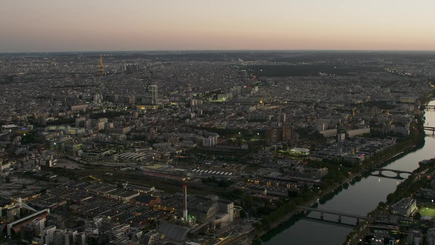 The sun sets on the horizon of a city skyline