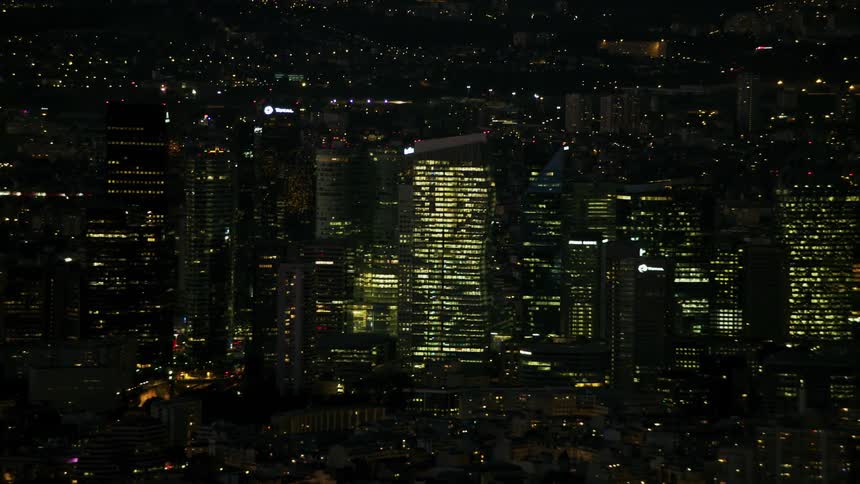 City skyscrapers glow in the night sky