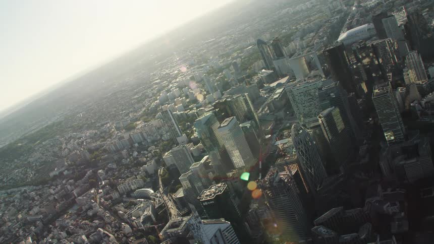 The sun shines down on city skyscrapers