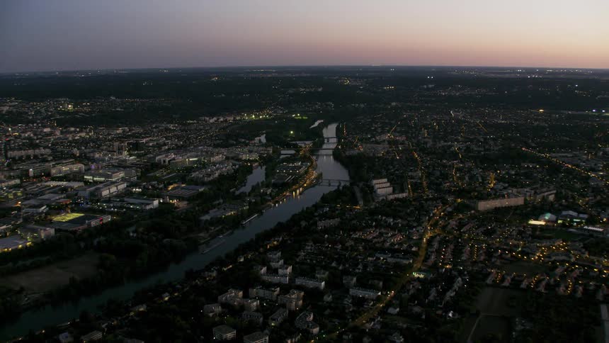 The city is brightly lit with water going through the center