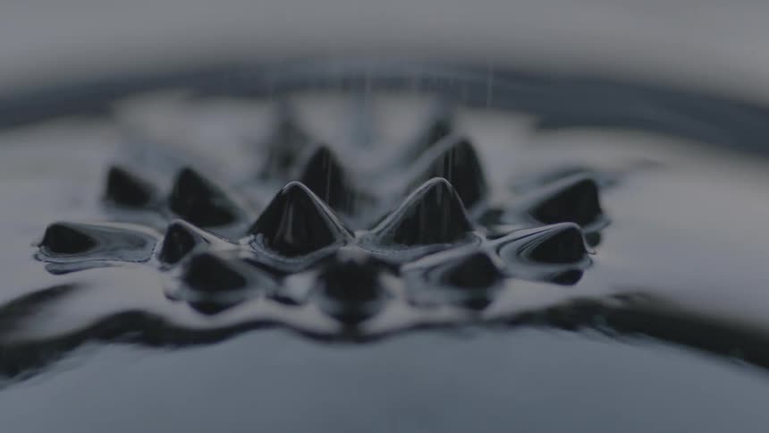 Sand sprinkling on black liquid