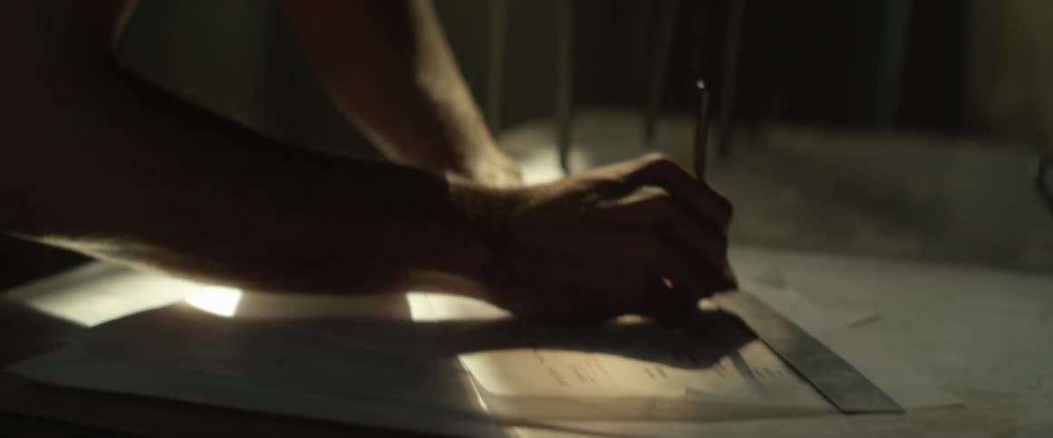 A man sketches in a workshop