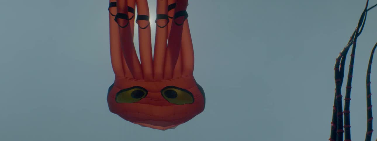 An octopus kite floats in the sky on a sunny day
