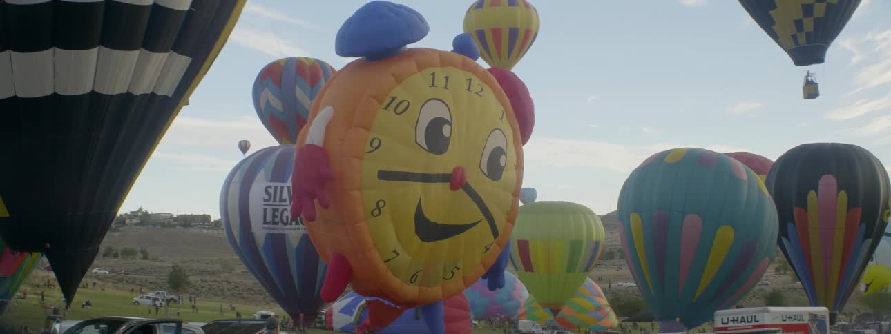 Hot air balloons sway in the breeze as they are are preparing to fly