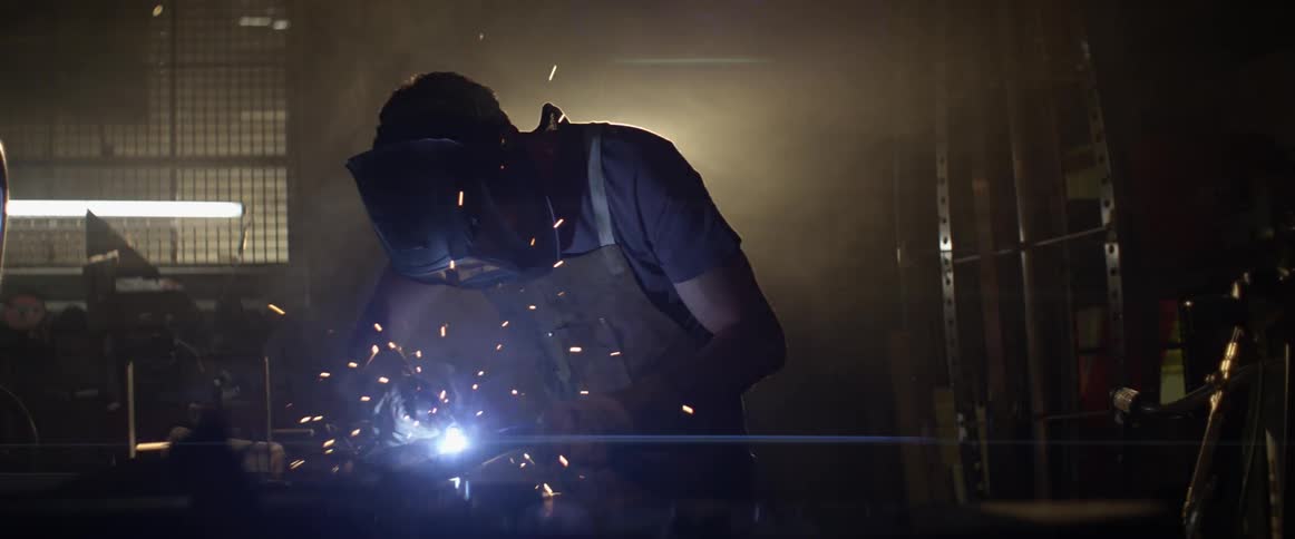 A man is wielding something in his workshop