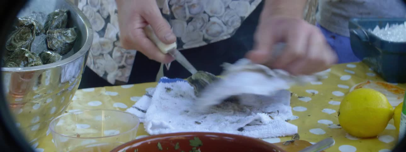 A man cuts open oysters and puts them on ice