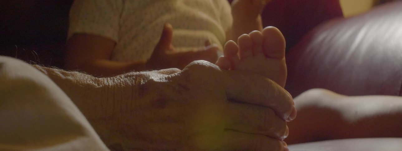 A person rubs the foot of a baby