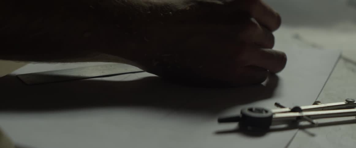 A man draws lines with a ruler