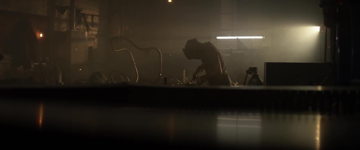 A man welds inside a workshop