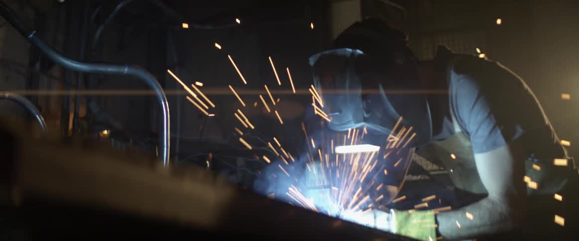 A man welds in a workshop