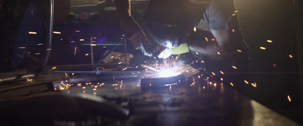 Welder welds in a workshop
