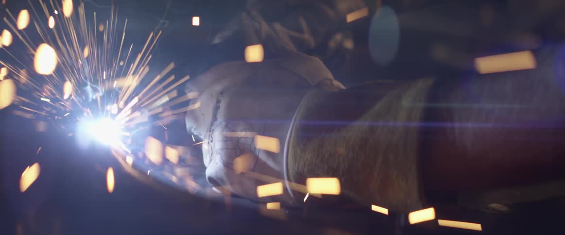 A person welding a pipe