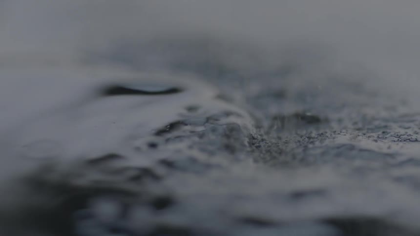 Powder pours onto black liquid