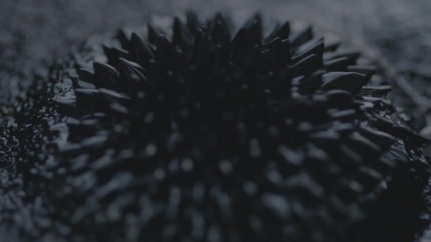 Black liquid pulsates into spikes
