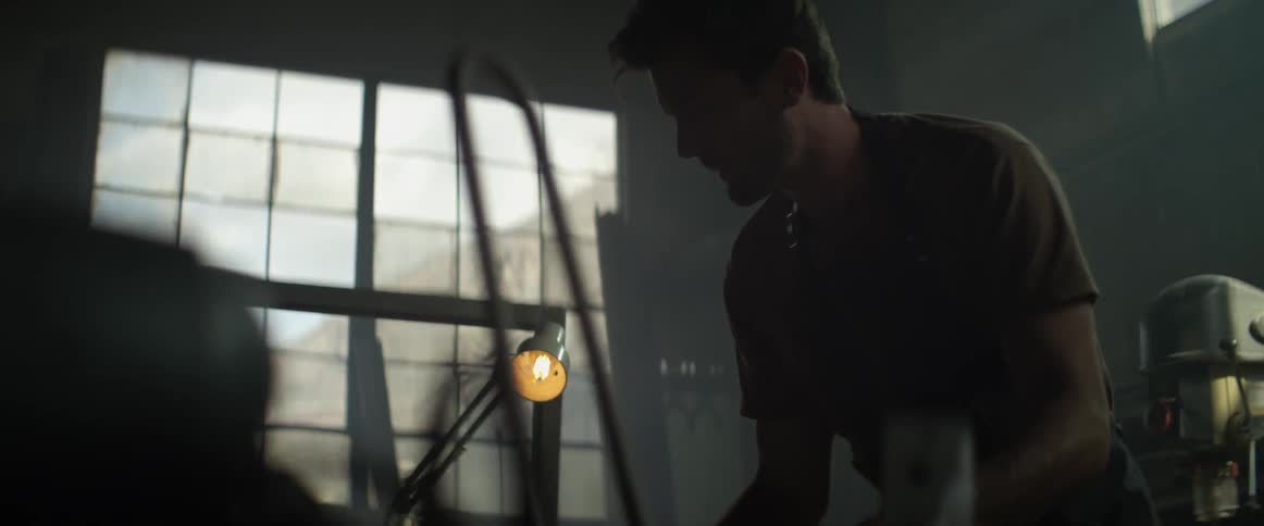 A man is working at his work bench
