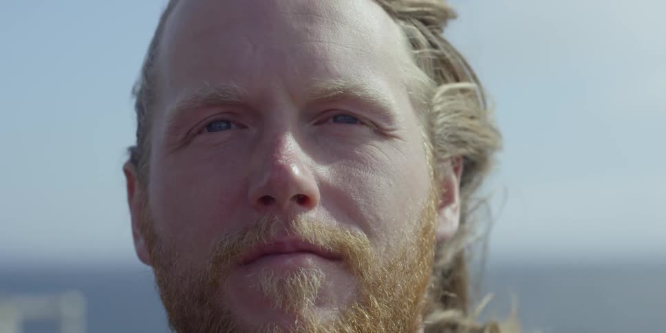 A man stands outside in the wind