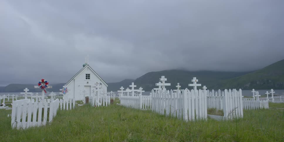 A graveyard with a small white building