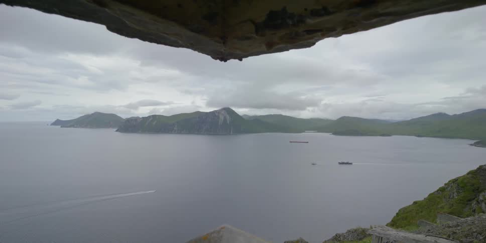 Boats float on the ocean on a cloudy day