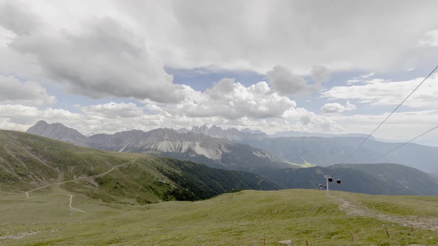 Clouds pass over mountains and chair lifts