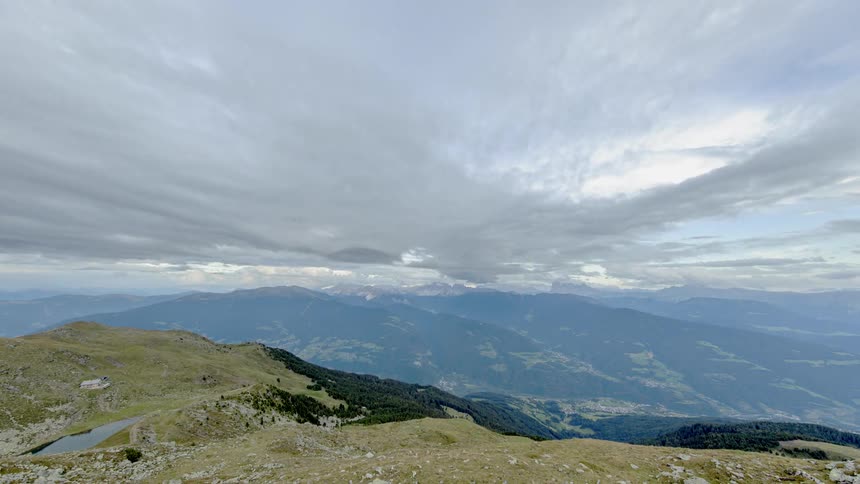 Clouds roll past a mountain range