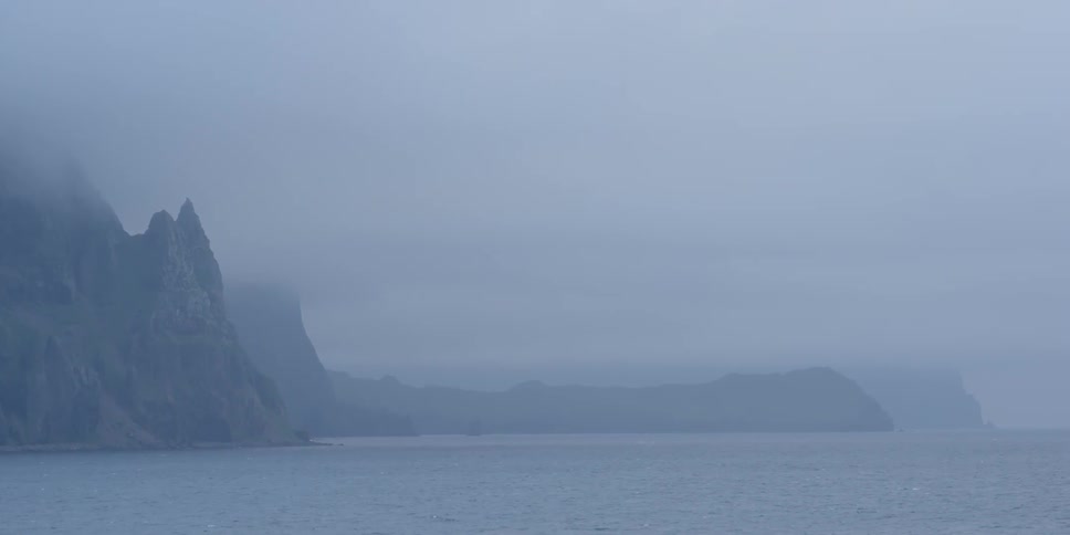 Fog hangs above the water