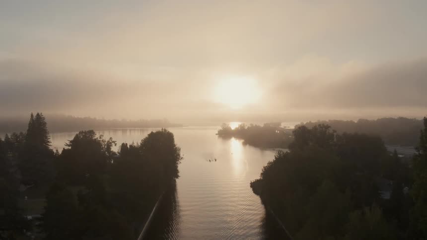 Pullback from Union Bay along the Montlake Cut during a foggy sunrise