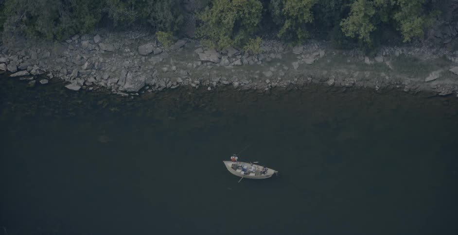 A fishing boat floats on a lake