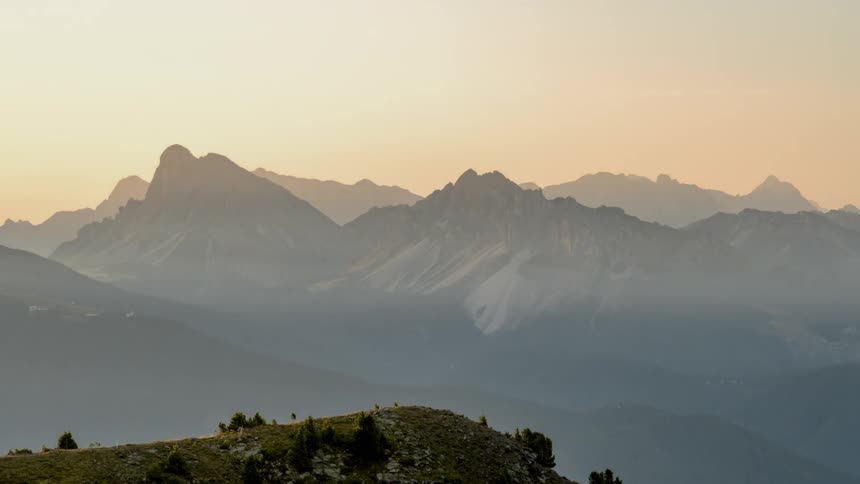 Fog passing over jagged mountains