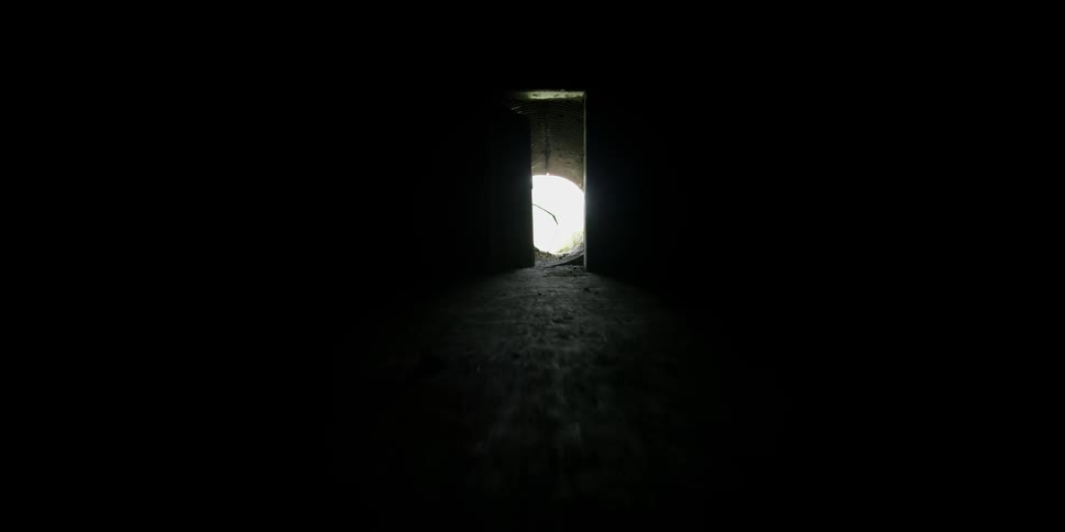 Sunlight shines at the end of a tunnel