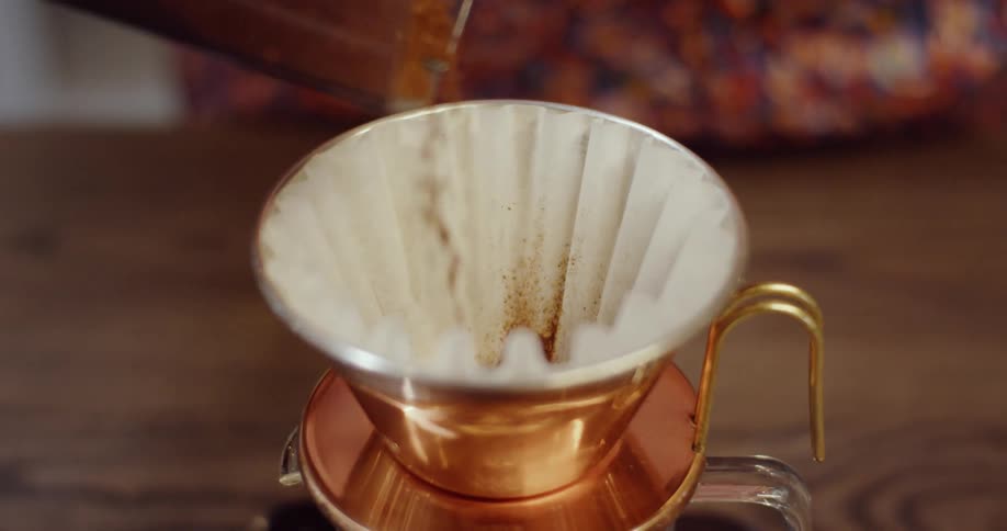 Coffee grounds are poured into a coffee filter