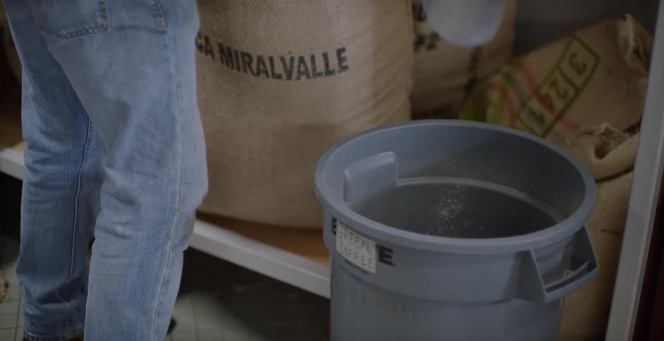 Man scoops grain into a bin