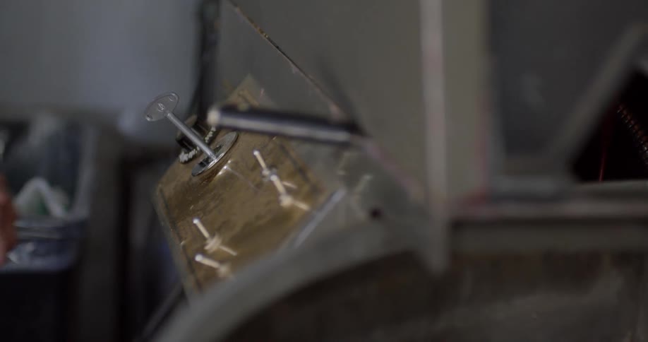 A man turns the knob on a machine