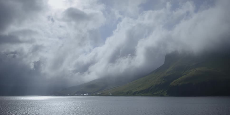 Sun shining through clouds over the ocean