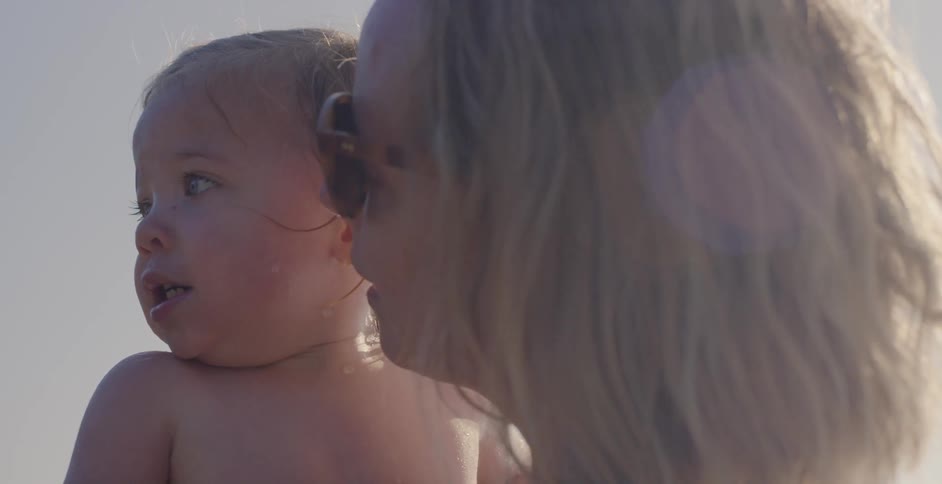 A woman holds a baby