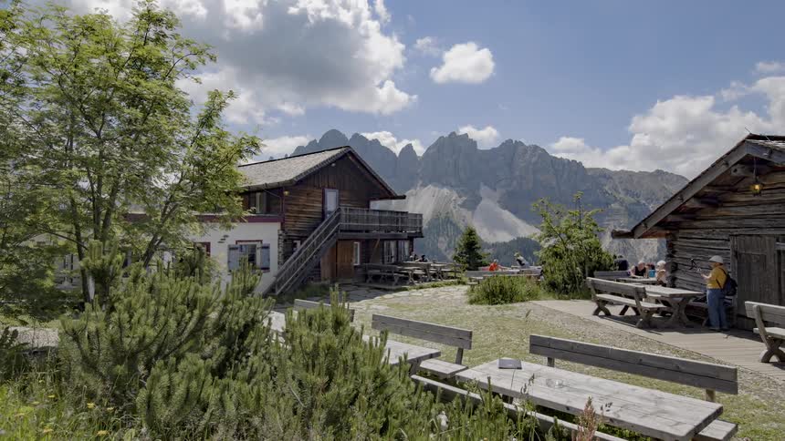 Clouds pass over log cabins in the mountains