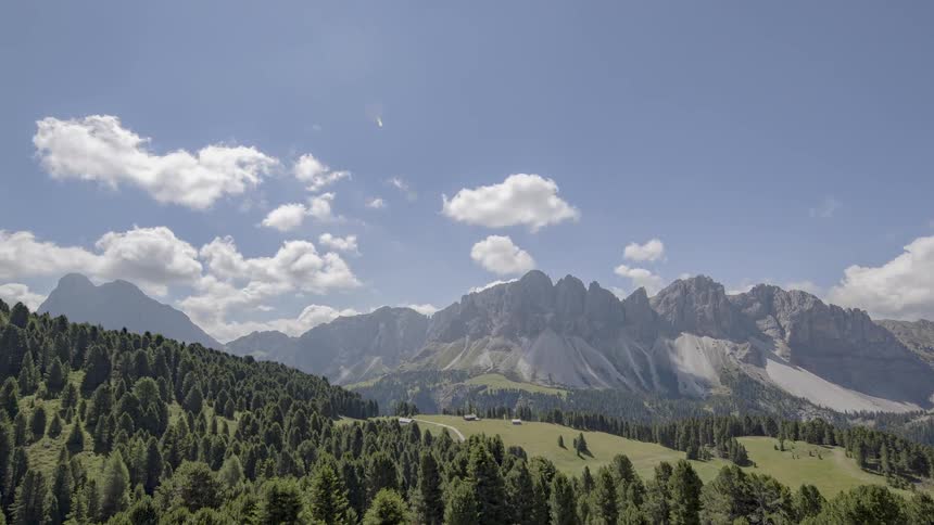 Clouds float over a rocky mountain ridge
