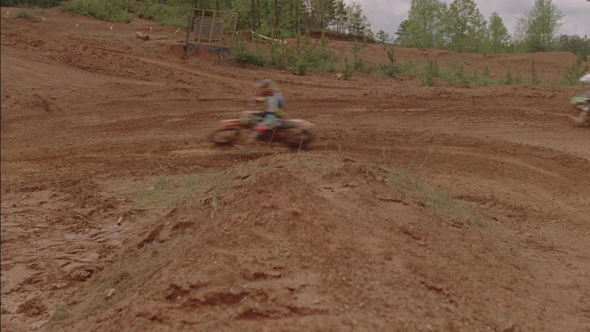 People racing on dirt bikes