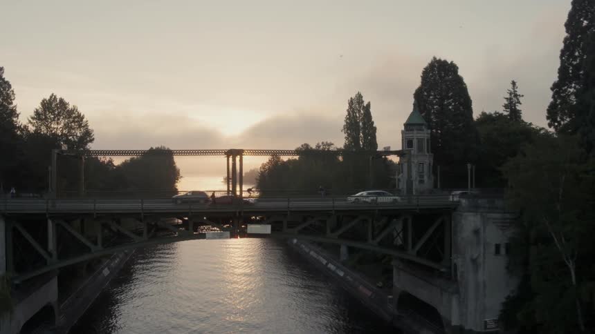 Ascending along the Montlake Cut as the sun rises over Lake Washington in the distance