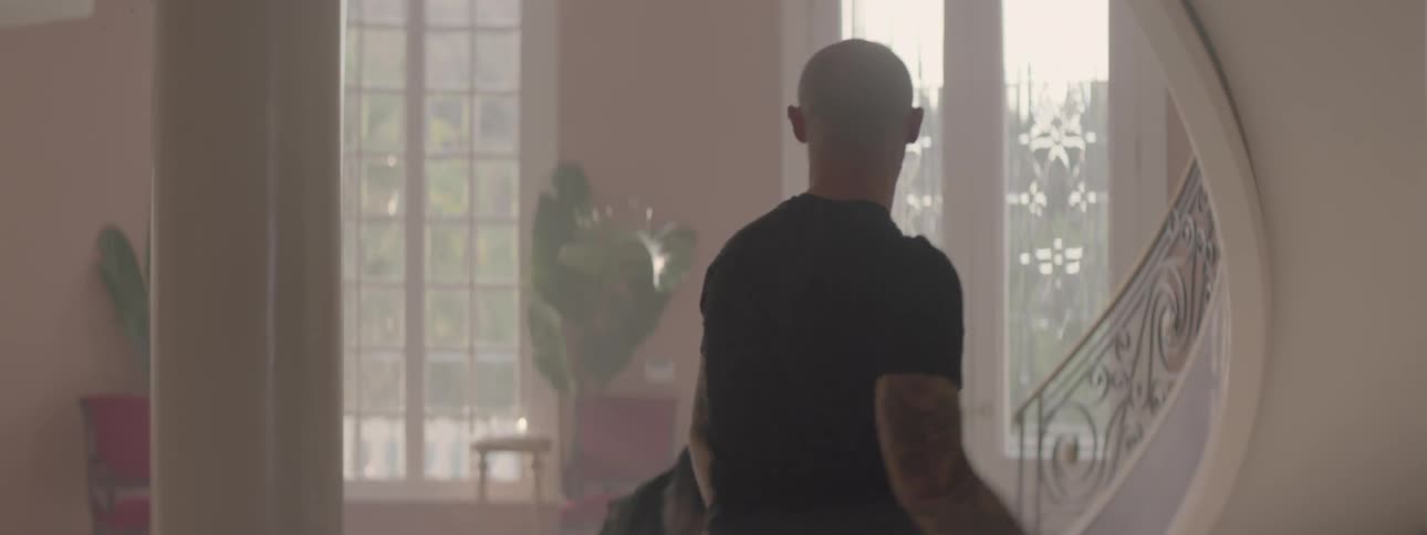 Two men fist fight in a house