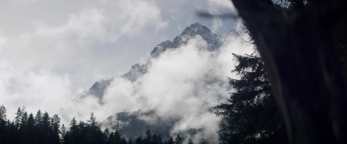 Fog in front of a jagged mountain