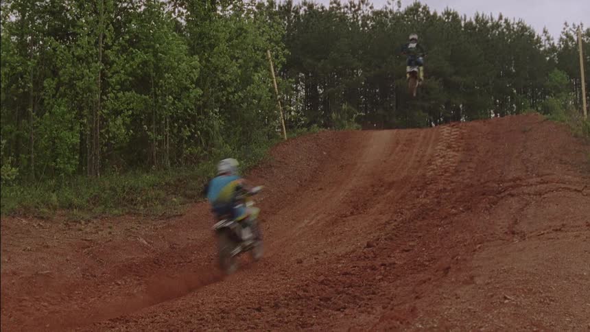 Dirt bike riders are taking their bikes off a jump