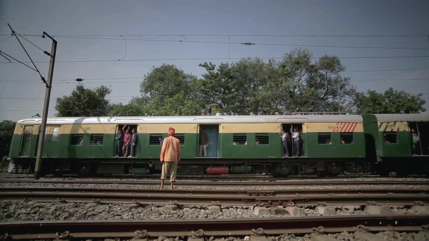 Man watching a train pass by