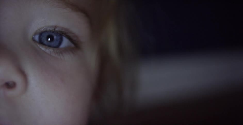 A child stares forward into light