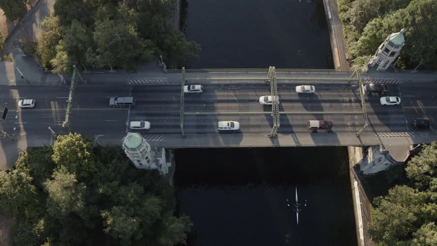 Flying parallel to the Montalke Bridge as rowers glide along below